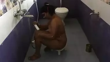 Fat Indian female with a mask on her face performs porn showering