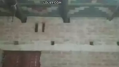 Village girl applying lotion to full nude body